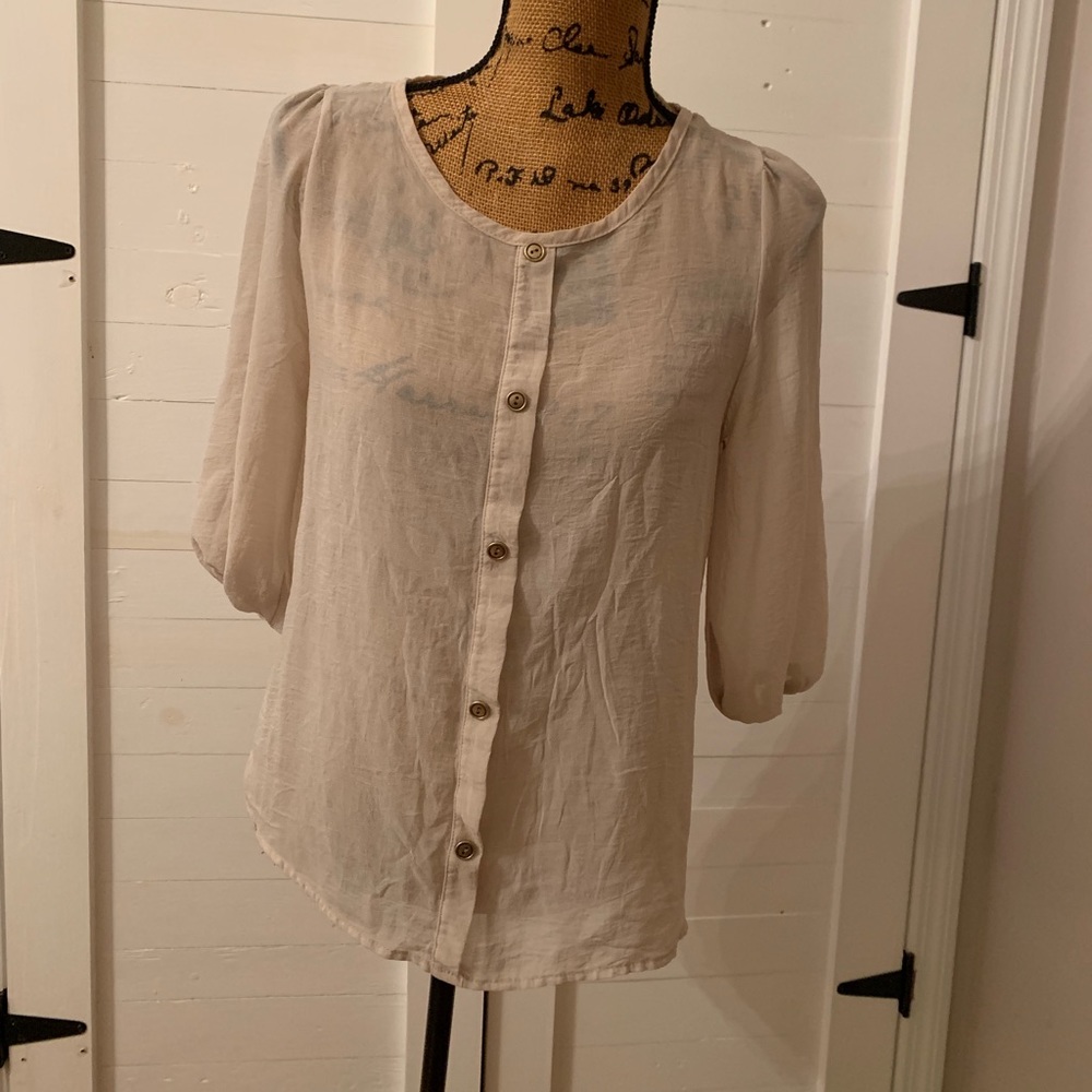 Miami. Sheer blouse with gold button detail.